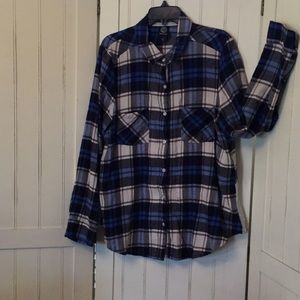 Plaid flannel shirt with flounce in back.